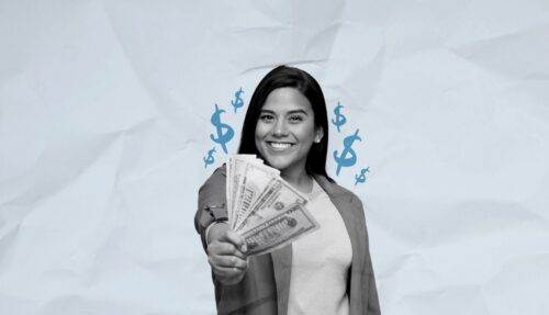 Person smiling while holding a first of US currency.